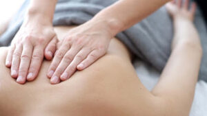 Close up of back massage procedure in spa salon