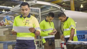 photo-man-looking-at-paperwork-in-startrack-parcels-facility.jpg.auspostimage.1170_0.169.medium